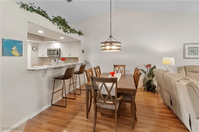 a view of a dining room with furniture and a chandelier
