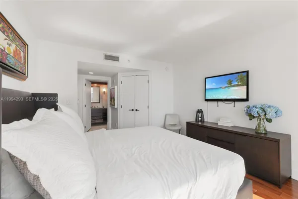 a bedroom with a bed and a chandelier