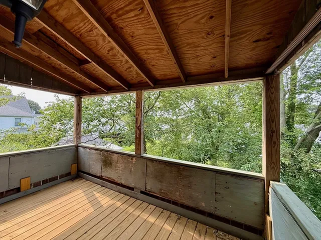 a view of balcony with wooden floor