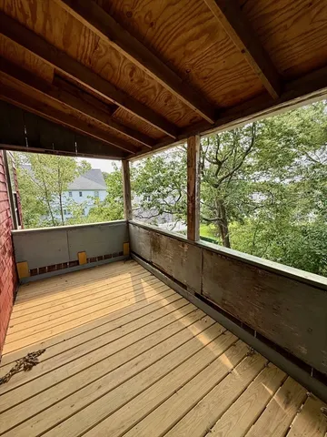 a view of empty room with wooden floor and outdoor space