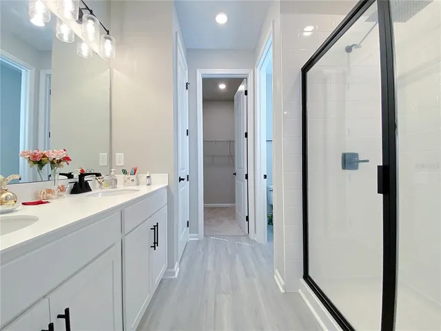 a bathroom with a granite countertop sink mirror and toilet