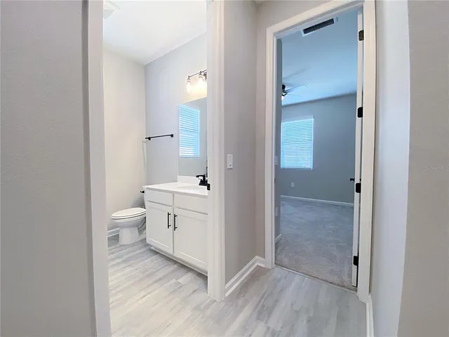 an empty room with windows and closet