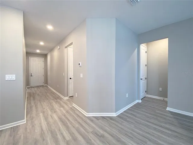 a view of kitchen with sink microwave and refrigerator