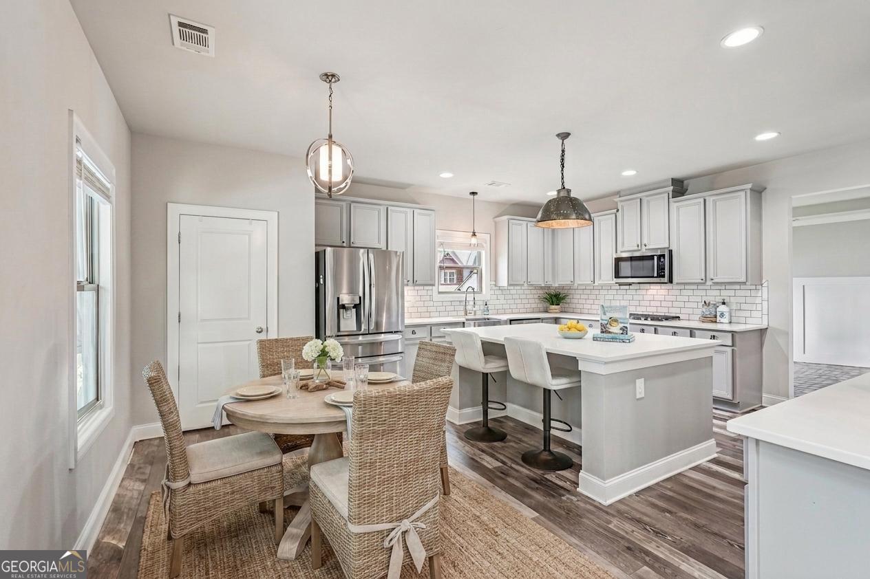 17 Lake Sydney Drive Dawsonville, GA 30534 - Photo 6 of 52 a kitchen that has a lot of white cabinets and stainless steel appliances