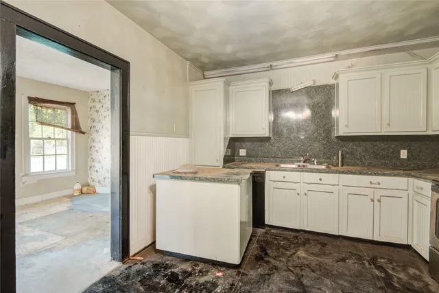 a kitchen with a sink stove and cabinets