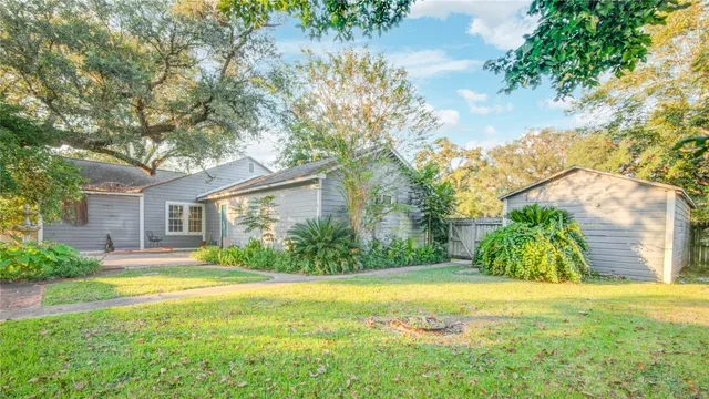 a view of backyard of house with green space