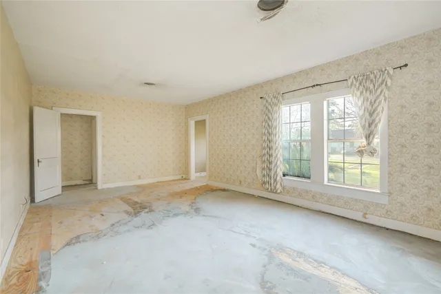 an empty room with a empty space and windows