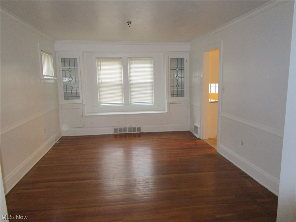 3796 Lowell Road Cleveland Heights, OH 44121 - Photo 2 of 11 Unfurnished room featuring ornamental molding and dark hardwood / wood-style flooring