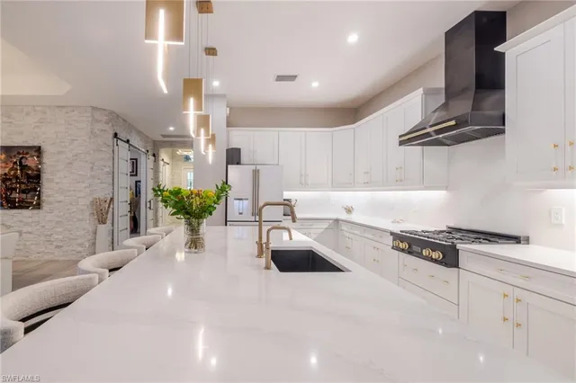a kitchen with stainless steel appliances kitchen island granite countertop a sink and cabinets
