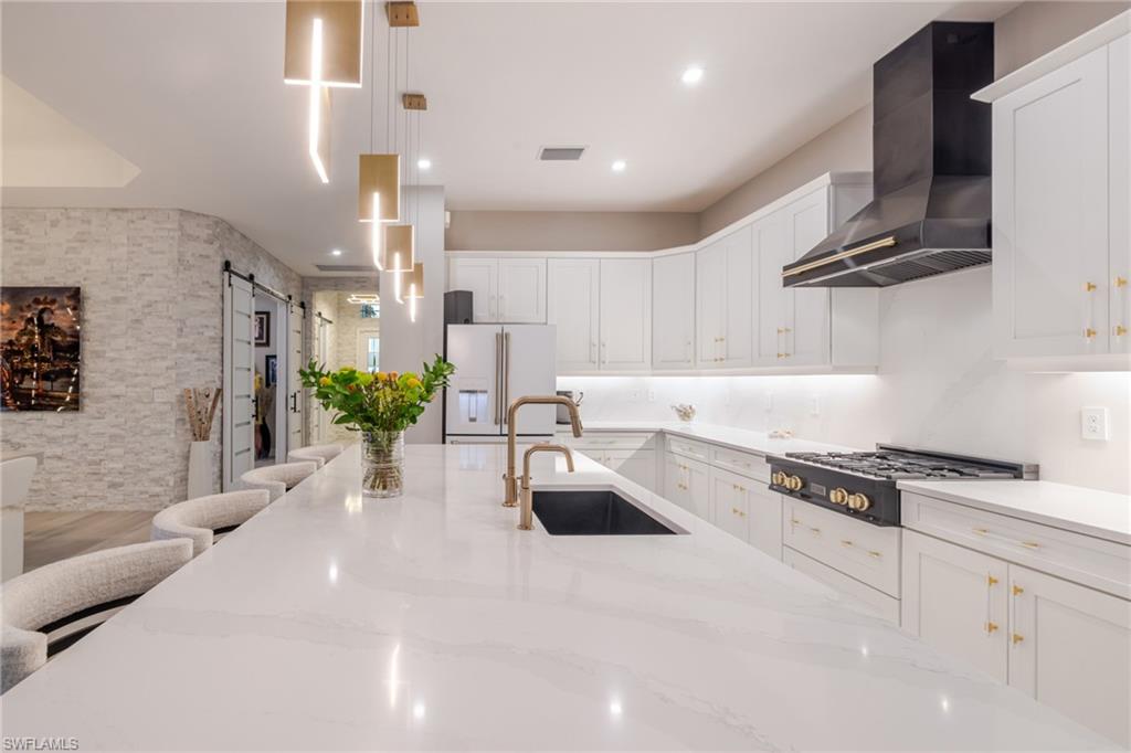 13543 Blue Bay Circle Fort Myers, FL 33913 - Photo 11 of 45 a kitchen with stainless steel appliances kitchen island granite countertop a sink and cabinets