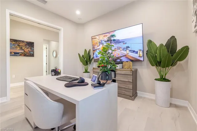 a dining room with furniture and a potted plant