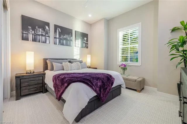 a bedroom with a bed dresser and a window