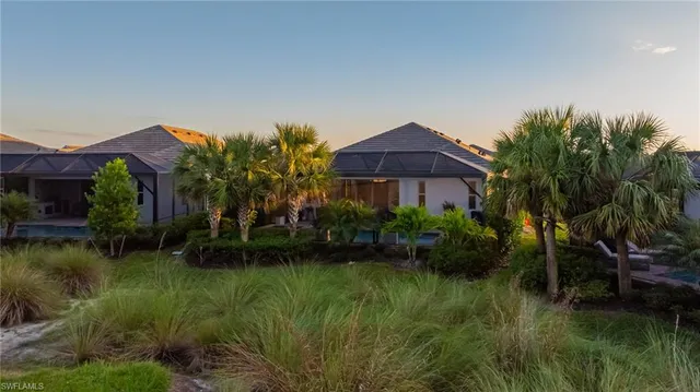 a backyard of a house with lots of green space and lake view