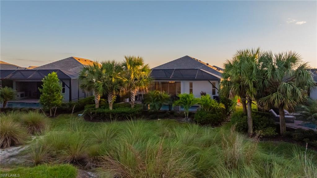 13543 Blue Bay Circle Fort Myers, FL 33913 - Photo 37 of 45 a backyard of a house with lots of green space and lake view
