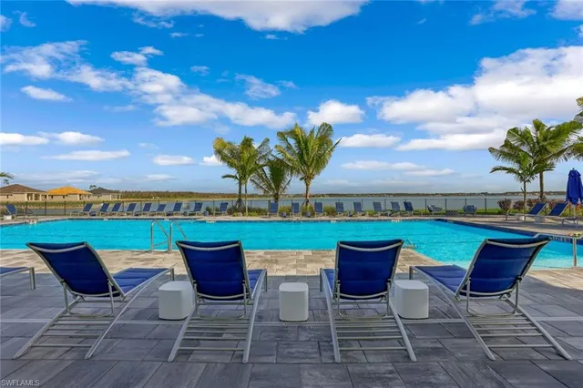 a view of a patio with table and chairs barbeque potted plants and palm tree