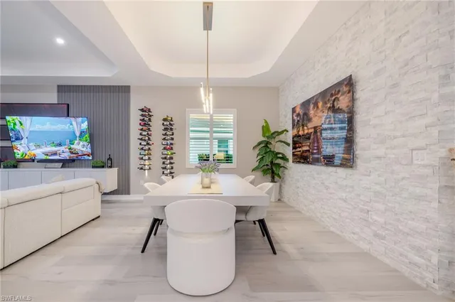 a living room with furniture a chandelier and a flat screen tv