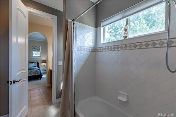 a bathroom with a sink double vanity granite tub and shower