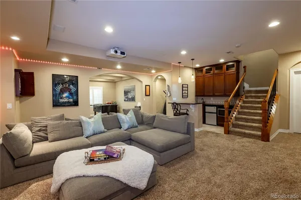 a living room with furniture and a projector screen