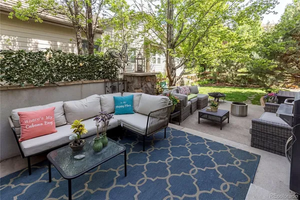 a view of backyard of house with outdoor seating and green space