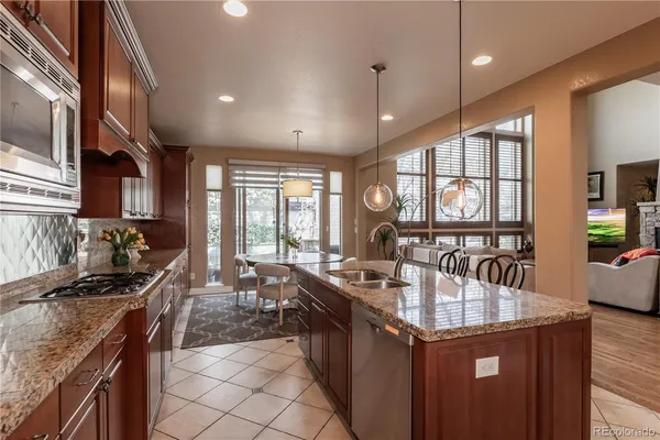 a kitchen with counter top space a sink appliances and cabinets