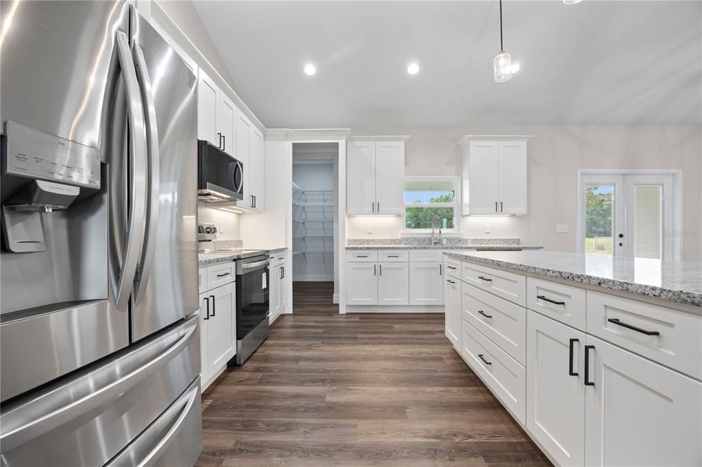 151 Southwest Scott Place Lake City, FL 32024 - Photo 11 of 47 a large white kitchen with stainless steel appliances