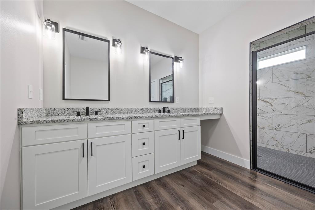 151 Southwest Scott Place Lake City, FL 32024 - Photo 19 of 47 a bathroom with a granite countertop sink double and mirror