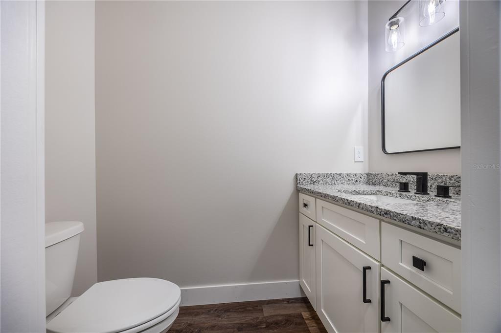 151 Southwest Scott Place Lake City, FL 32024 - Photo 26 of 47 a bathroom with a granite countertop toilet sink and mirror