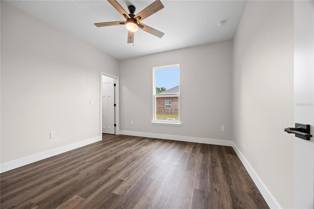 151 Southwest Scott Place Lake City, FL 32024 - Photo 28 of 47 wooden floor in an empty room with a window