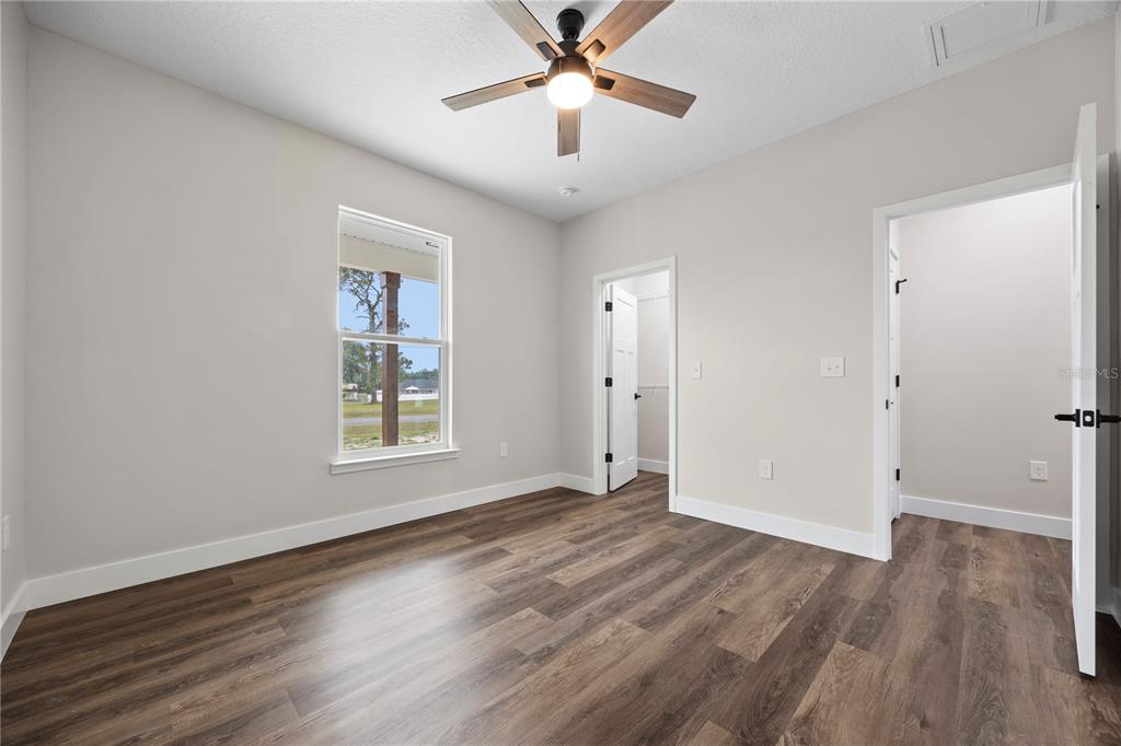 151 Southwest Scott Place Lake City, FL 32024 - Photo 30 of 47 a view of an empty room with wooden floor and a window