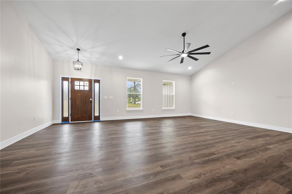 151 Southwest Scott Place Lake City, FL 32024 - Photo 6 of 47 a view of an empty room with window and wooden floor