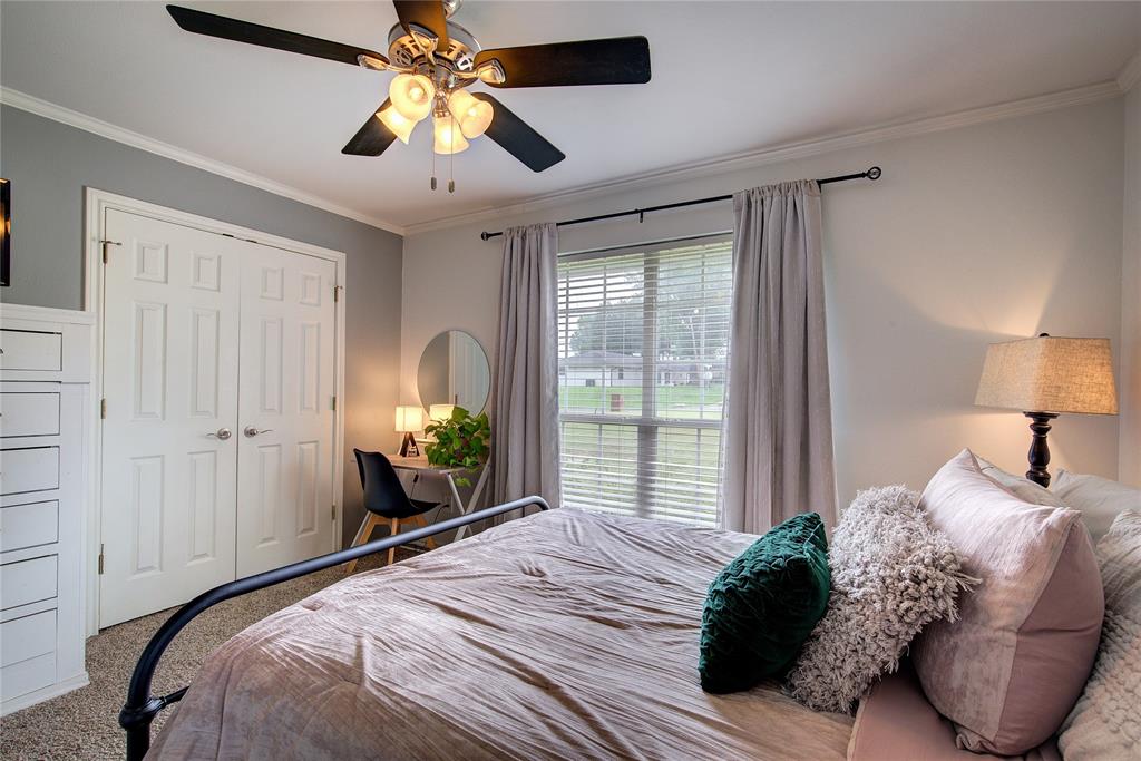 2027 Park Springs Road Sulphur Springs, TX 75482 - Photo 26 of 39 a bedroom with a bed and a chandelier