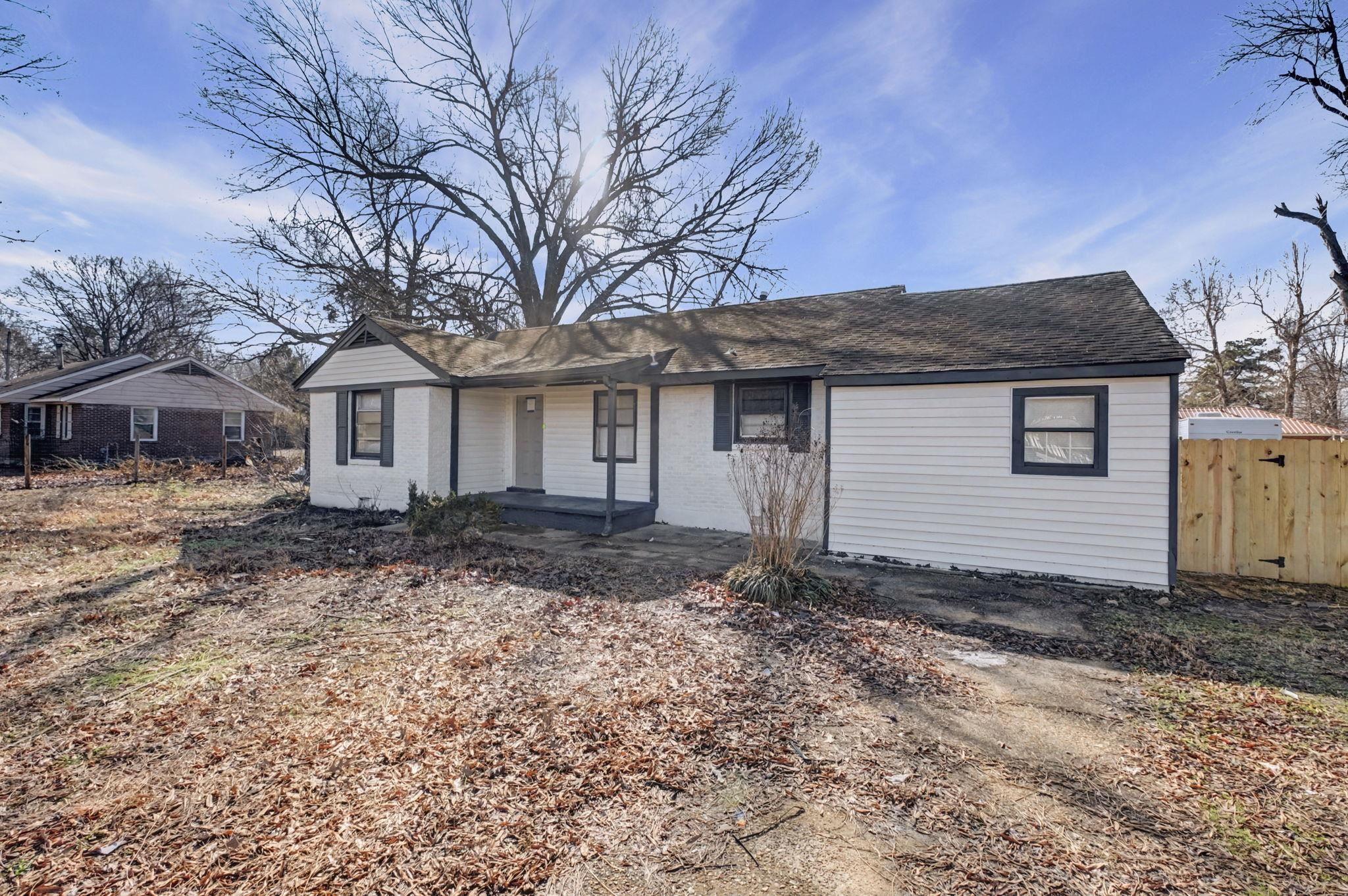 6733 Navy Road Millington, TN 38053 - Photo 15 of 25 a house with trees in front of it