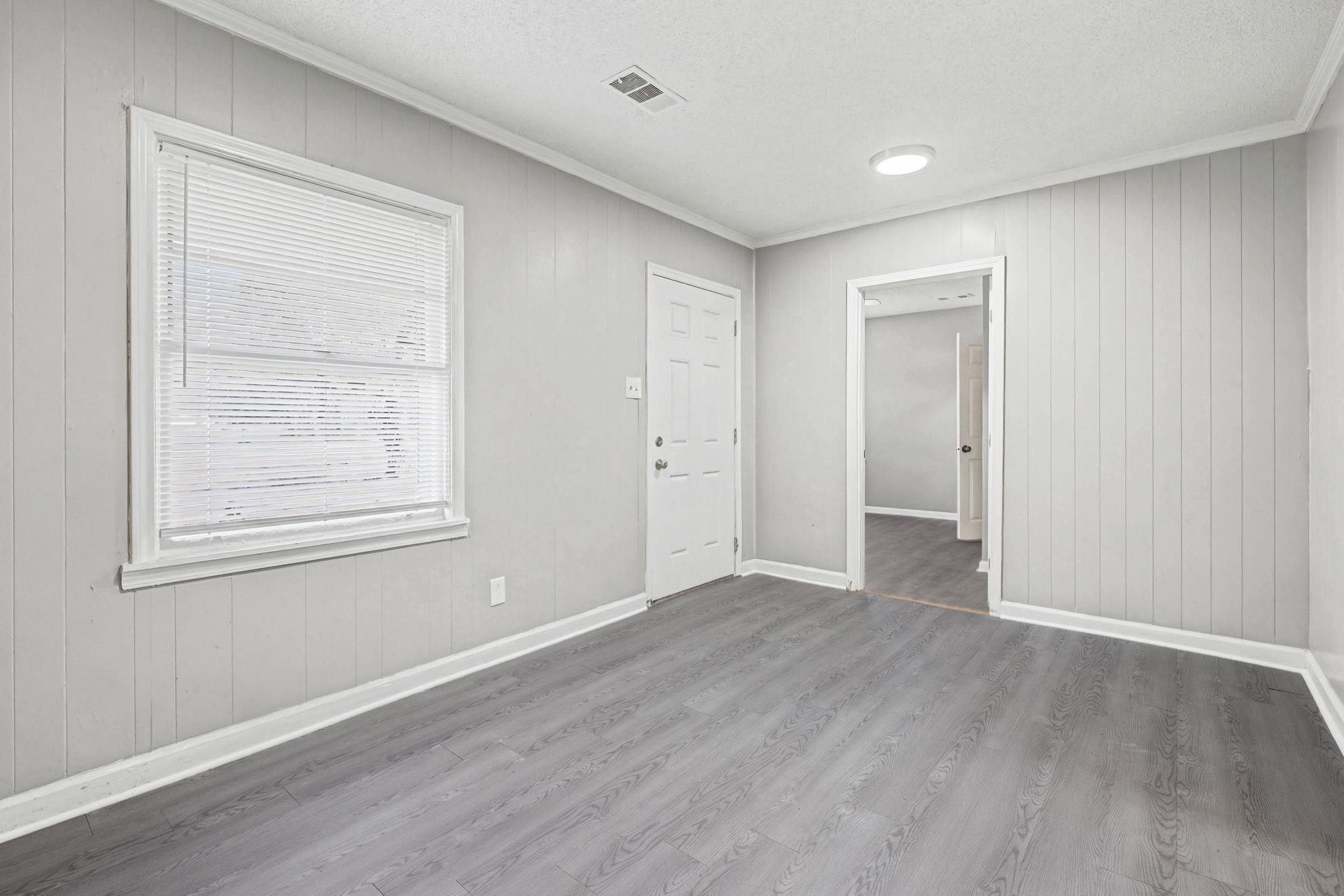 6733 Navy Road Millington, TN 38053 - Photo 18 of 25 a view of an empty room with wooden floor and a window