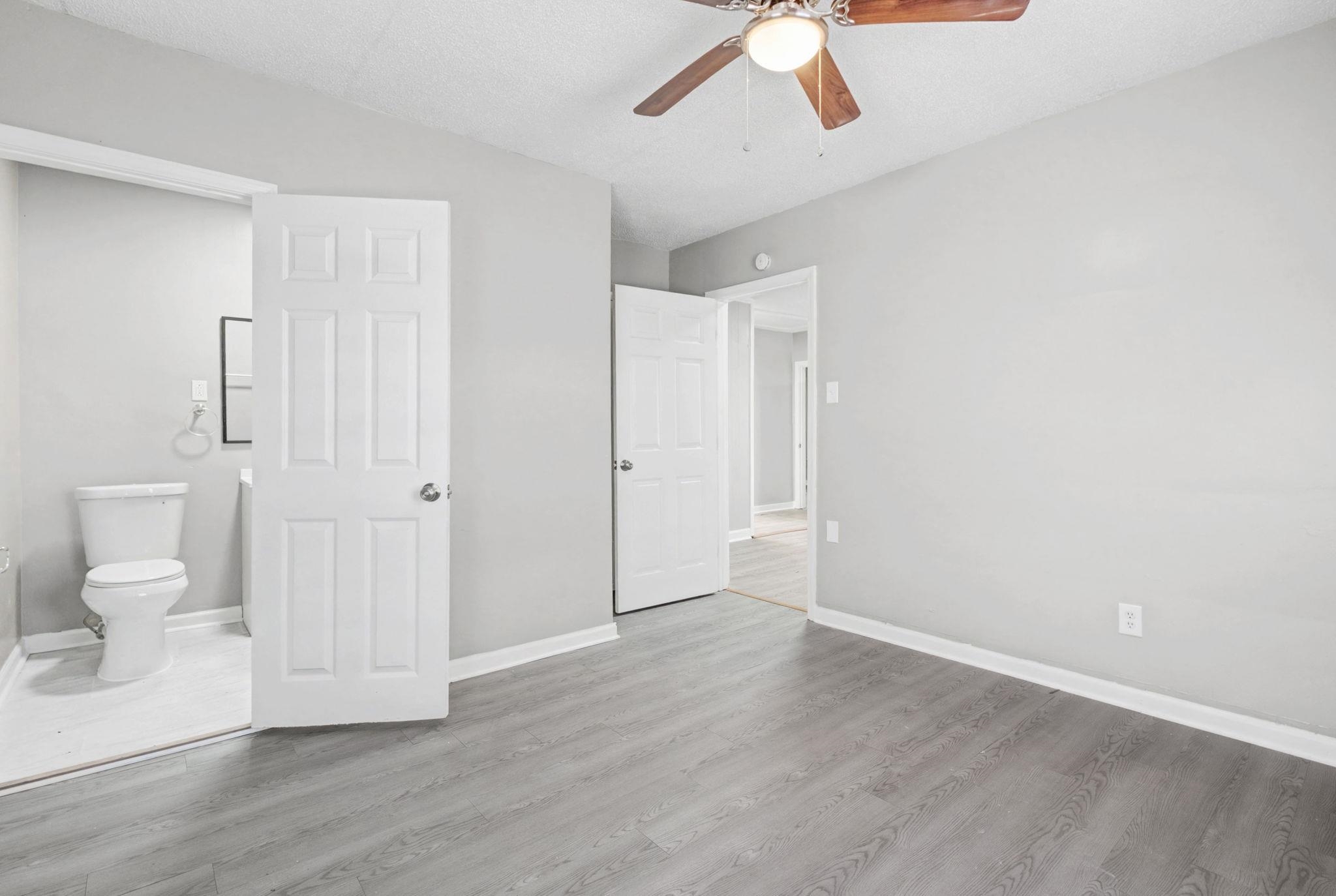 6733 Navy Road Millington, TN 38053 - Photo 2 of 25 a view of a bathroom with wooden floor and toilet