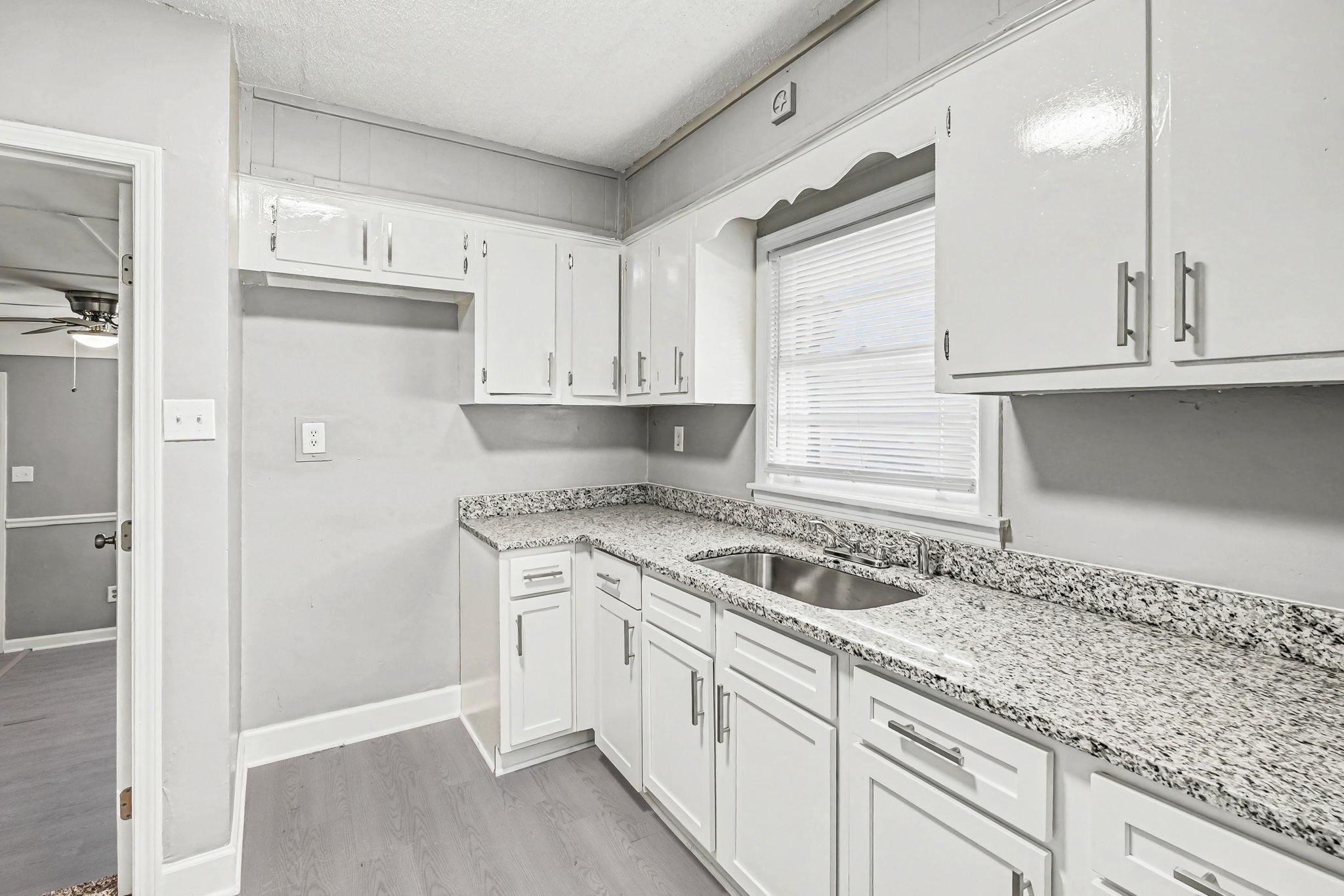 6733 Navy Road Millington, TN 38053 - Photo 20 of 25 a kitchen with granite countertop a sink and cabinets