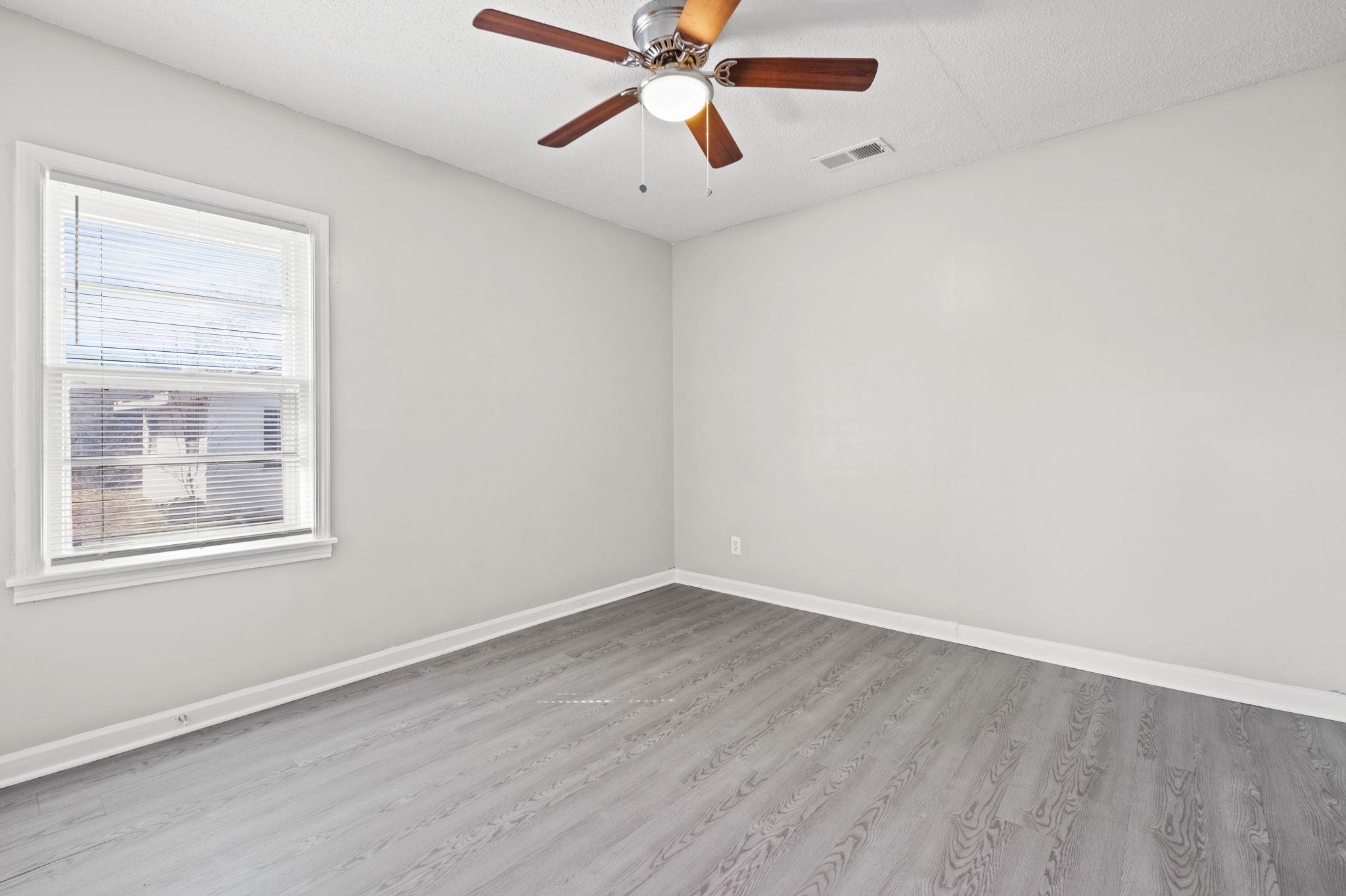 6733 Navy Road Millington, TN 38053 - Photo 4 of 25 an empty room with a window and a fan