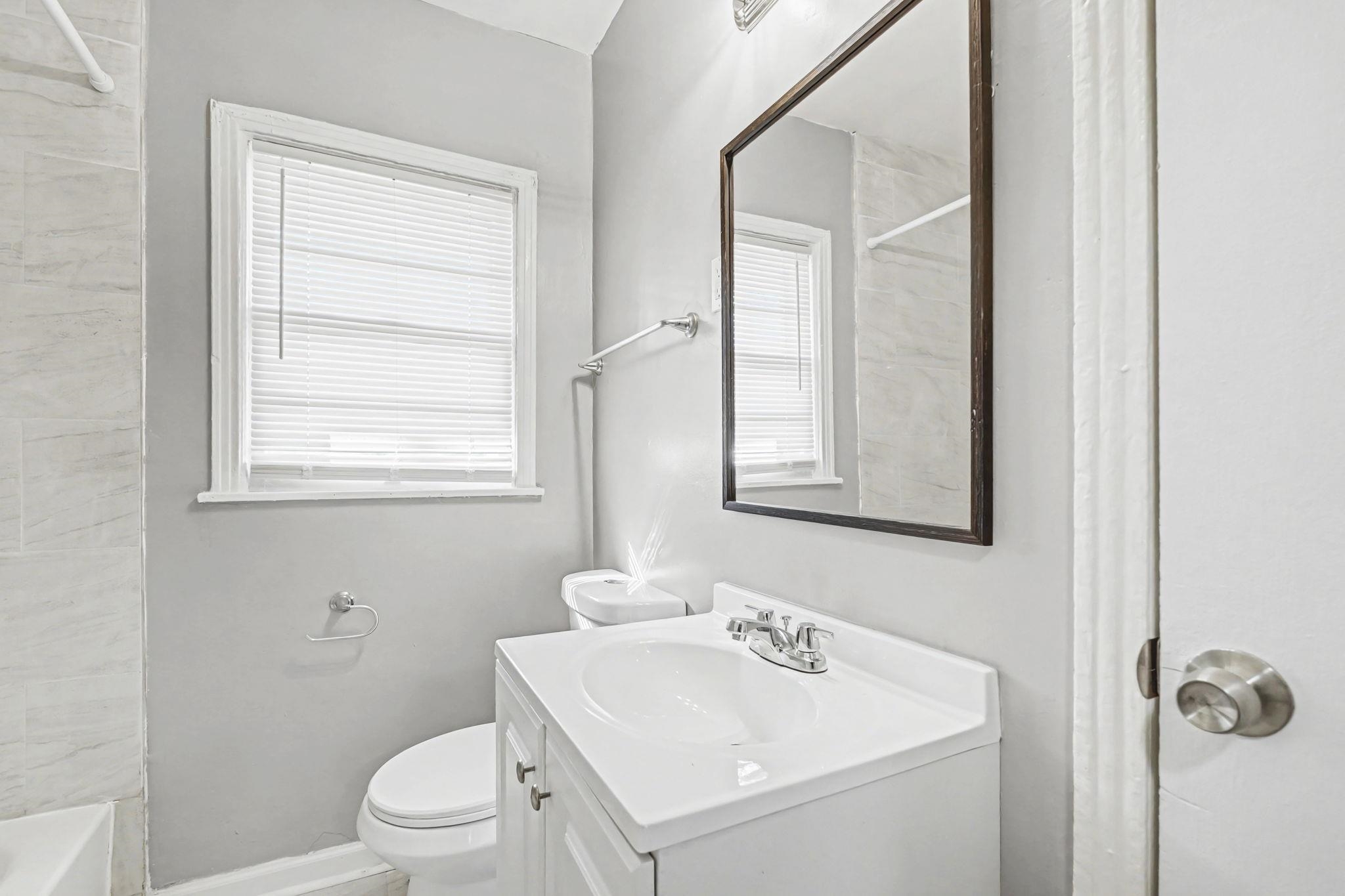 6733 Navy Road Millington, TN 38053 - Photo 6 of 25 a bathroom with a toilet sink and mirror
