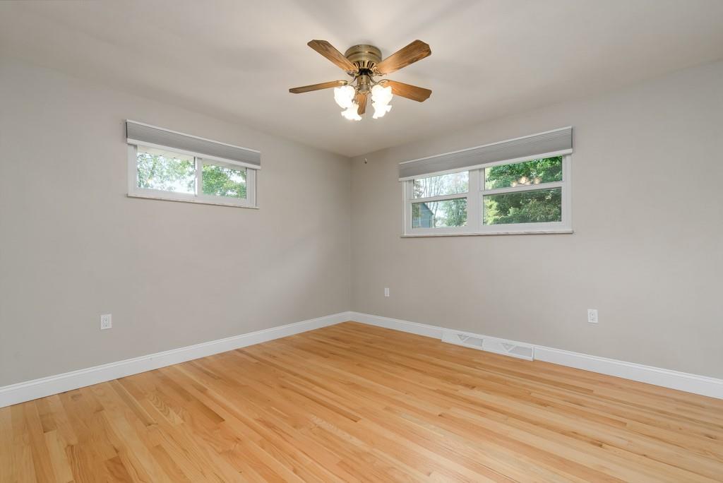 6130 Orchard Lane Butler, PA 16002 - Photo 17 of 24 a view of an empty room with wooden floor and a ceiling fan