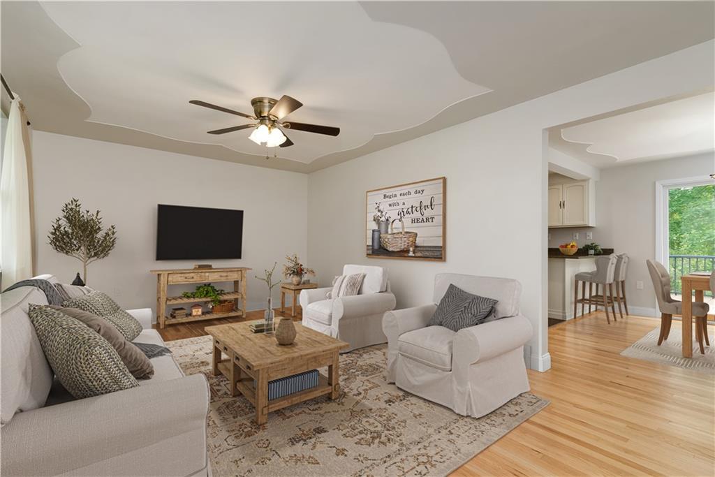 6130 Orchard Lane Butler, PA 16002 - Photo 5 of 24 a living room with furniture a flat screen tv and a fireplace