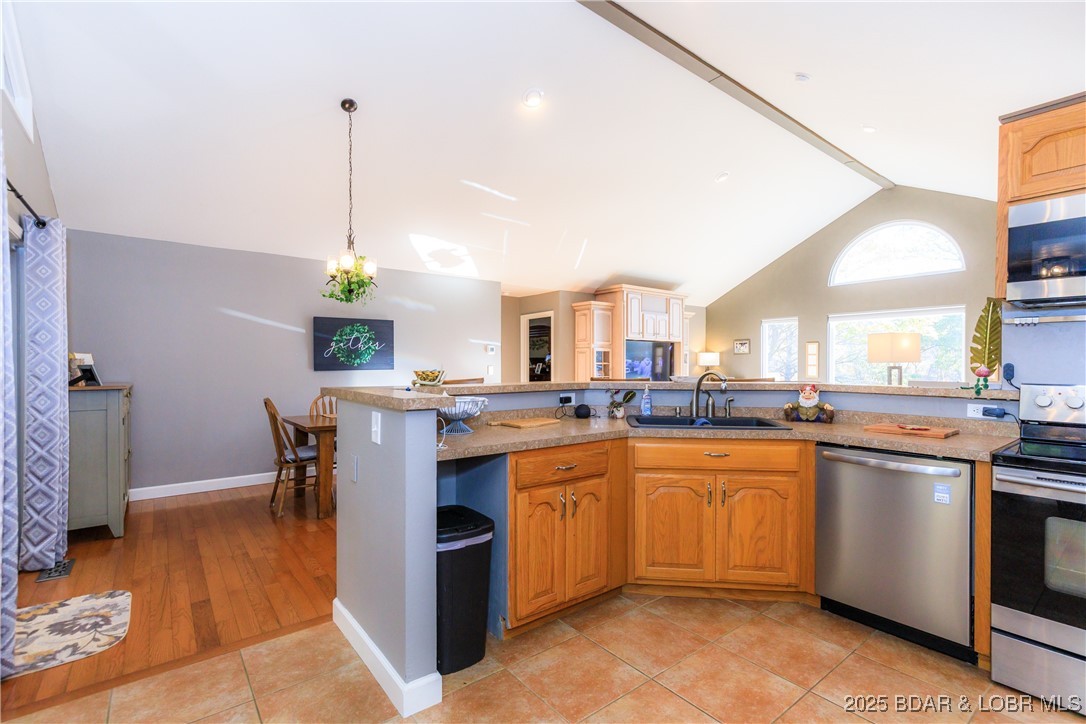 23 Leisure Road Eldon, MO 65026 - Photo 6 of 58 Vaulted Ceilings with hardwood floors and tiled ki