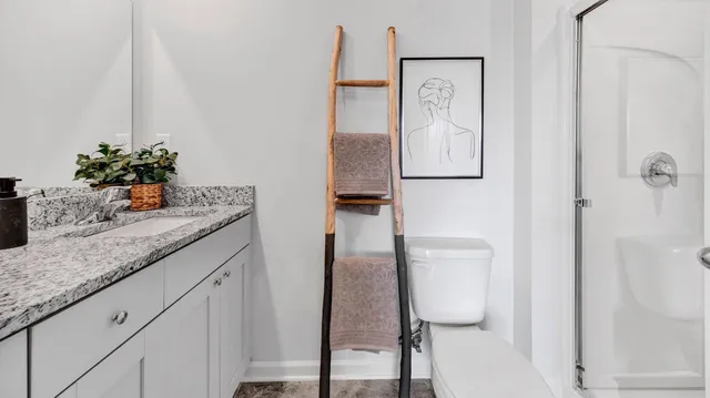 a hallway with painting on the wall and a potted plant