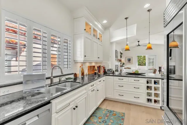 a kitchen with counter top space sink and cabinets