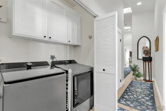 a utility room with sink dryer and washer