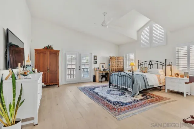 a bedroom with furniture and a flat screen tv