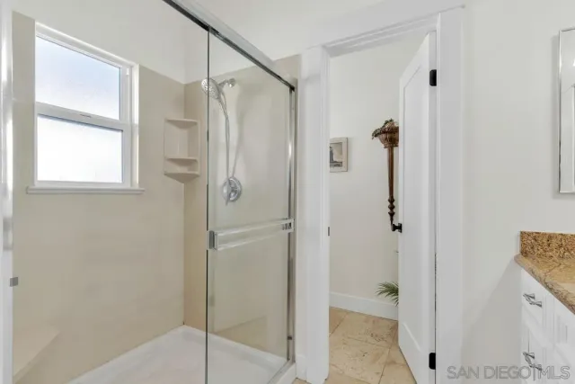 a bathroom with a shower and a sink