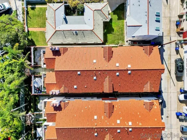an aerial view of residential houses with outdoor space