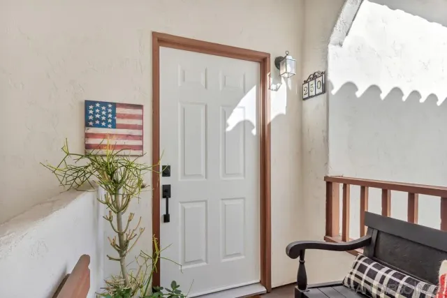 a view of a hallway with wooden floor and a potted plant