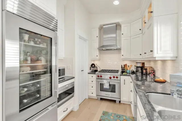a kitchen with stainless steel appliances granite countertop a stove and a sink