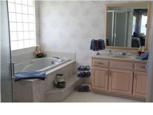 2557 Crescent Road Navarre, FL 32566 - Photo 12 of 48 a bathroom with a sink a vanity and a mirror