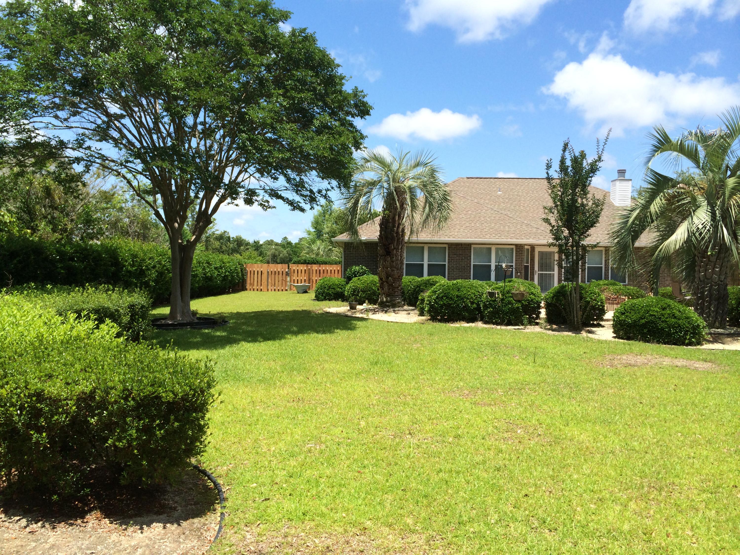 2557 Crescent Road Navarre, FL 32566 - Photo 16 of 48 a view of backyard of house with green space